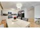 Open-concept kitchen and dining area with stylish lighting and modern appliances at 5323 Hansel Ave # E14, Orlando, FL 32809