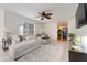 Spacious living room with comfortable seating, a ceiling fan, and open access to other rooms at 5323 Hansel Ave # E14, Orlando, FL 32809