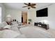 Spacious living room featuring a ceiling fan, large TV, and comfortable sectional sofa at 5323 Hansel Ave # E14, Orlando, FL 32809