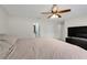Main bedroom with a large bed, fan, and access to a bathroom at 5323 Hansel Ave # E14, Orlando, FL 32809
