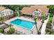 Aerial view of a community pool surrounded by manicured landscaping and cozy lounge areas at 5323 Hansel Ave # E14, Orlando, FL 32809