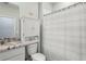Cozy bathroom featuring a shower/tub combo and built-in storage above the toilet for convenience at 5395 Sunshine Dr, Wildwood, FL 34785