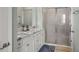 Well-lit bathroom with granite countertop vanity and a glass-enclosed shower at 5395 Sunshine Dr, Wildwood, FL 34785