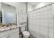 Cozy bathroom featuring a shower/tub combo and built-in storage above the toilet for convenience at 5395 Sunshine Dr, Wildwood, FL 34785