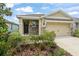 Charming single-story home with well-maintained landscaping, beautiful lawn, and a welcoming entry at 5395 Sunshine Dr, Wildwood, FL 34785