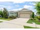 Charming single-Gathering home featuring a well-maintained lawn, two car garage, and inviting curb appeal at 5395 Sunshine Dr, Wildwood, FL 34785