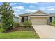 Charming single-story home with well-maintained landscaping, beautiful lawn, and two car garage at 5395 Sunshine Dr, Wildwood, FL 34785