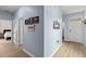Inviting entryway with light blue walls and luxury vinyl plank flooring leading into the living spaces at 5395 Sunshine Dr, Wildwood, FL 34785