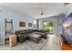 Cozy living room with a large sectional sofa, ceiling fan, and decor elements, creating a relaxing and inviting atmosphere at 5395 Sunshine Dr, Wildwood, FL 34785