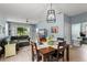 Open-concept layout with a dining area, living room, and sliding glass doors that provide ample natural light and access to the outdoors at 5395 Sunshine Dr, Wildwood, FL 34785