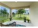 Relaxing covered patio with lush greenery views at 5395 Sunshine Dr, Wildwood, FL 34785