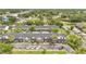 Aerial view of multi-Gathering home with parking, trees, and green spaces surrounding the building at 5662 Royal Pine Blvd # 24, Orlando, FL 32807