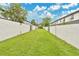 Spacious, well-maintained backyard featuring lush green grass and a high privacy fence at 5662 Royal Pine Blvd # 24, Orlando, FL 32807