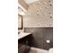 Elegant half bathroom featuring bird-themed wallpaper, wainscoting, and a stylish dark vanity at 5662 Royal Pine Blvd # 24, Orlando, FL 32807