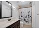 Bathroom features a large mirror over the vanity and a shower-tub combination with decorative curtain at 5662 Royal Pine Blvd # 24, Orlando, FL 32807