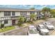 Multi-Gathering exterior features parking spaces, well-manicured shrubbery, and covered entryways at 5662 Royal Pine Blvd # 24, Orlando, FL 32807