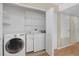 Bright laundry room equipped with modern appliances and plenty of shelving for organized storage at 5662 Royal Pine Blvd # 24, Orlando, FL 32807