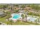 Aerial view of a community pool with plenty of lounge seating surrounded by lush landscaping at 5662 Royal Pine Blvd # 24, Orlando, FL 32807