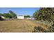Backyard view with chain link fence, and large grassy yard at 607 Escondido Ct, Kissimmee, FL 34758