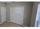 Bedroom featuring tile flooring, closet and a window at 607 Escondido Ct, Kissimmee, FL 34758