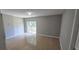 Spacious bedroom featuring neutral paint, tile flooring, and a sliding glass door leading to the backyard at 607 Escondido Ct, Kissimmee, FL 34758