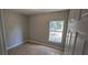 Neutral painted bedroom featuring tile flooring, a large window and base trim at 607 Escondido Ct, Kissimmee, FL 34758