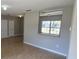 Spacious living room with ceramic tile flooring and a view of the outdoors from a pass through window at 607 Escondido Ct, Kissimmee, FL 34758