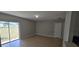Spacious living area featuring neutral paint, tile flooring, and a sliding glass door leading to the backyard at 607 Escondido Ct, Kissimmee, FL 34758