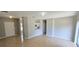 Spacious living area featuring neutral paint, tile flooring, and an open kitchen at 607 Escondido Ct, Kissimmee, FL 34758