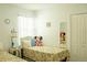 Bright bedroom with colorful bedding, comfortable furnishings, and plenty of natural light at 608 Washington Way, Haines City, FL 33844