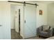 Bedroom featuring modern barn door with access to closet and ensuite at 608 Washington Way, Haines City, FL 33844