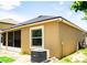Back exterior view of the home showing the air conditioner, window, and screened patio at 608 Washington Way, Haines City, FL 33844