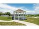 White gazebo in a community featuring a picnic table and walking path on a bright day at 608 Washington Way, Haines City, FL 33844