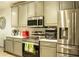 Modern kitchen features stainless steel appliances and gray cabinets, offering a sleek design at 608 Washington Way, Haines City, FL 33844