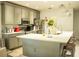 Modern kitchen with stainless steel appliances, a spacious island, and ample cabinet space at 608 Washington Way, Haines City, FL 33844