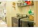 Modern laundry room featuring updated washer and dryer with shelving above at 608 Washington Way, Haines City, FL 33844