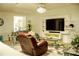Comfortable living room with stylish furnishings, a large-screen TV, and a relaxing ambiance at 608 Washington Way, Haines City, FL 33844
