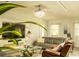 Relaxing living room featuring a ceiling fan, large-screen TV, and comfortable seating arrangements at 608 Washington Way, Haines City, FL 33844