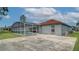 The backyard boasts a screened-in pool and an open concrete patio next to the gray home exterior at 611 Jura Ln, Kissimmee, FL 34759