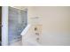 Bathroom featuring frameless glass shower and soaking tub with tile surround at 611 Jura Ln, Kissimmee, FL 34759