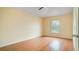 Clean, bright bedroom features tiled flooring, a window with blinds, and neutral walls, ready for personalization at 611 Jura Ln, Kissimmee, FL 34759