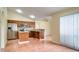 Kitchen with wood cabinets, stainless steel appliances, and center island at 611 Jura Ln, Kissimmee, FL 34759