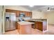 Kitchen with wood cabinets, stainless steel appliances, and center island with granite countertop at 611 Jura Ln, Kissimmee, FL 34759