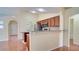 The kitchen area with stainless steel appliances and a granite bar top at 611 Jura Ln, Kissimmee, FL 34759