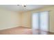 An empty living room space has tile floors, light yellow walls, and a ceiling fan, ready for customization at 611 Jura Ln, Kissimmee, FL 34759