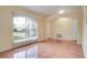 Bright living area features a large window, tiled flooring, and easy access to other areas of the home at 611 Jura Ln, Kissimmee, FL 34759