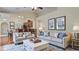 The staged living room showcases neutral furniture, decor, and an open layout to the kitchen at 611 Jura Ln, Kissimmee, FL 34759