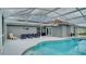 Outdoor pool area features modern outdoor seating, a grill, and a clear view of the pool at 611 Jura Ln, Kissimmee, FL 34759