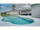 Outdoor pool is enclosed in a screened structure with an adjacent patio and stylish outdoor furniture at 611 Jura Ln, Kissimmee, FL 34759
