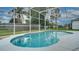 Sparkling backyard pool is surrounded by a screened enclosure and lush landscaping to provide a serene outdoor space at 611 Jura Ln, Kissimmee, FL 34759
